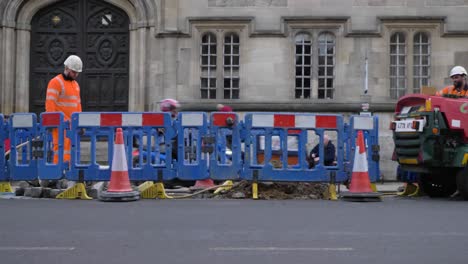 Wide-Shot-of-Road-Workers-Working-In-Between-Traffic-In-Oxford