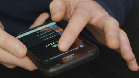 Close-Up-of-Hands-Using-COVID-Lockdown-Smartphone-Application