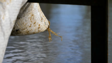 Extreme-Close-Up-of-Sandbag-In-Front-of-Flooded-Road