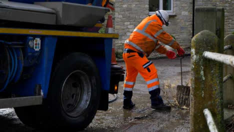 Handheld-Shot-of-Drainage-Worker-Pulling-Up-Strom-Drain-Cover-