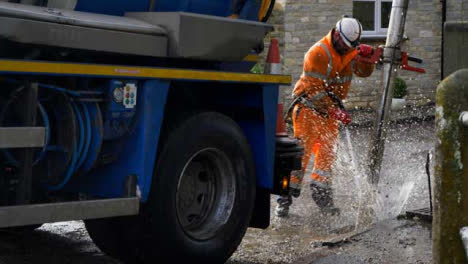 Handheld-Shot-of-Drainage-Worker-Using-High-Pressure-Hose-to-Clear-Out-Blocked-Drain