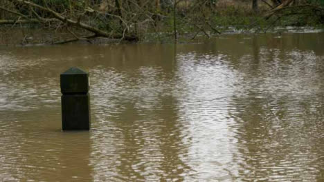 Long-Shot-of-Timber-Bollard-Almost-Entirely-Submerged-In-Water-During-Flood