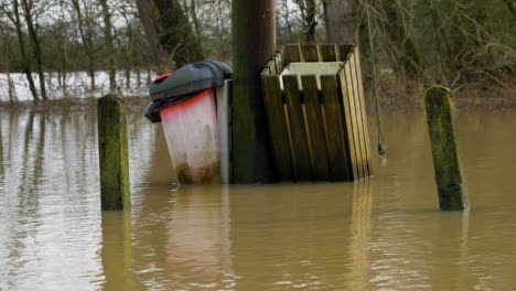 Medium-Shot-of-Submerged-Waste-Bins-In-Flooded-Village