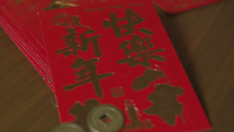 Sliding-Extreme-Close-Up-Shot-of-Chinese-New-Year-Red-Pockets-and-Coins