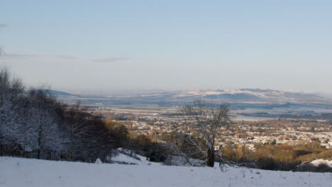 Panning-Shot-Overlooking-Snow-Covered-Hills-In-English-Countryside