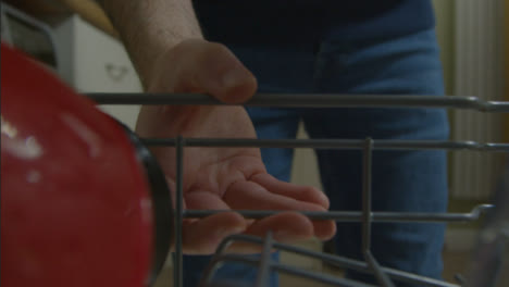 POV-Shot-of-Male-Opening-Dishwasher-Drawer-and-Placing-Mug-In-It