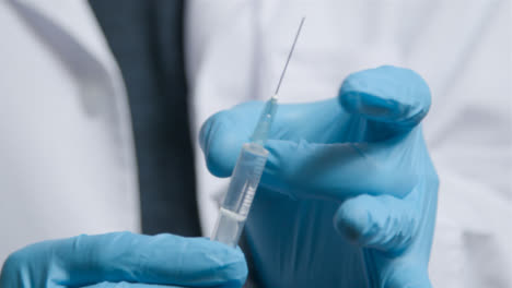 Close-Up-Shot-of-Medical-Professionals-Hand-Holding-COVID-Vaccine-Syringe-