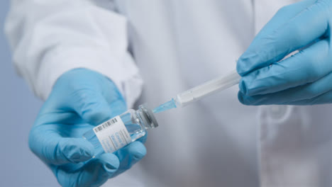 Close-Up-Shot-of-Medical-Professionals-Hand-Extracting-COVID-Vaccine-from-Vial-into-a-Syringe-