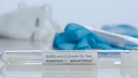 Sliding-Close-Up-Shot-of-COVID-Test-Tube-with-Negative-Result