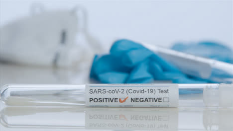 Sliding-Close-Up-Shot-of-COVID-Test-Tube-with-Positive-Result