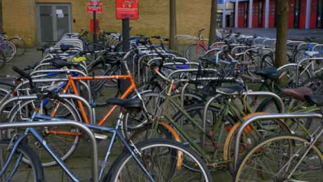 Pedestal-Shot-Rising-Up-Looking-at-Bicycles-Locked-to-Racks-