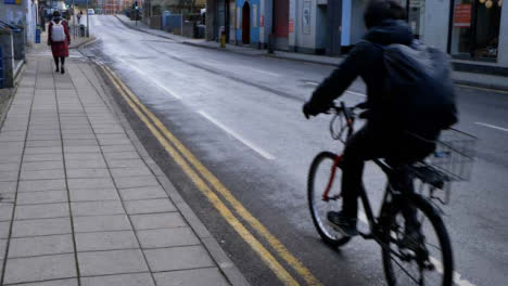 Wide-Angle-Shot-of-Cyclist-Riding-Down-Street