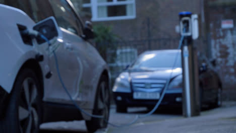 Defocused-Low-Angle-Shot-of-Electric-Car-Charging-On-Street-