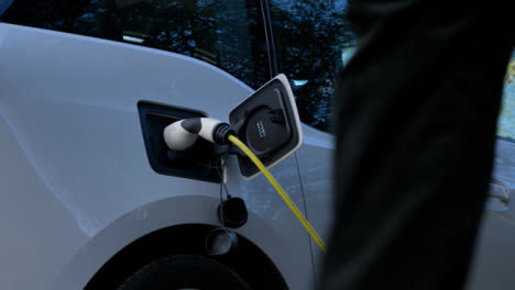 Low-Angle-Shot-Looking-Up-at-Charging-Cable-Plugged-into-Electric-Car