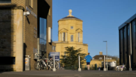 Defocused-Shot-of-Pedestrians-In-Front-of-Green-Templeton-College-Building