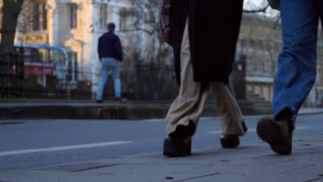 Low-Angle-Shot-of-Skater-as-Pedestrians-Walk-Past-In-Foreground