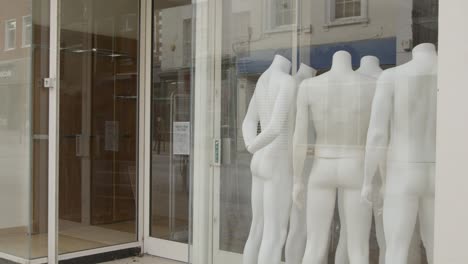 Tracking-Shot-Past-Shop-Window-Full-of-Disused-Mannequins