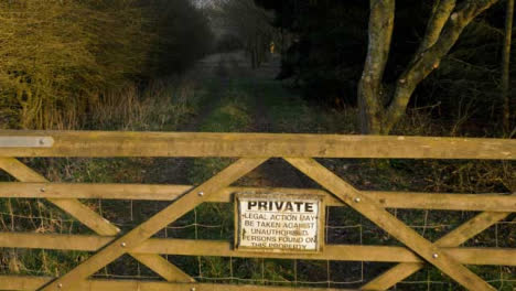 Tracking-Shot-Approaching-Private-Gate-Entrance-In-Field