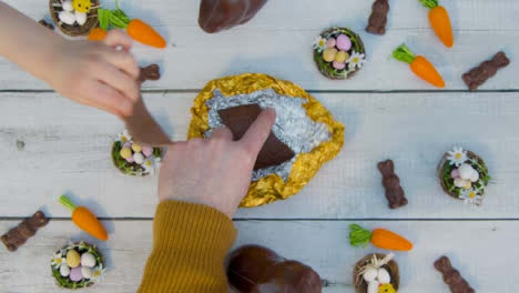 Overhead-Shot-of-Adult-and-Children's-Hands-Taking-Last-Pieces-of-Chocolate-Egg-