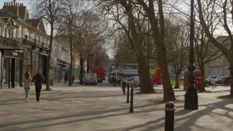 Wide-Shot-of-Pedestrians-Walking-Down-Street