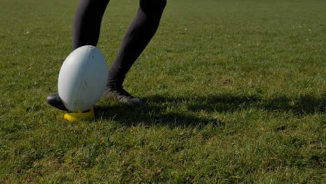 Medium-Shot-of-Rugby-Ball-Being-Kicked-from-Tee