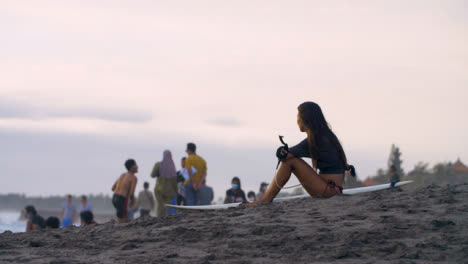 Handheld-Wide-Shot-of-Young-Woman-Sitting-On-Echo-Beach