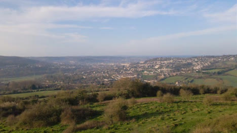 Drone-Shot-Flying-Over-Hills-Towards-City-of-Bath