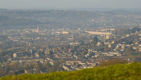 Pedestal-Shot-Rising-Up-Over-Small-Hill-and-Revealing-City-of-Bath