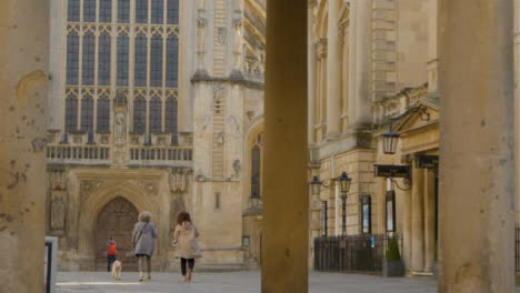 Wide-Shot-of-Dog-Walkers-Walking-Through-Abbey-Churchyard