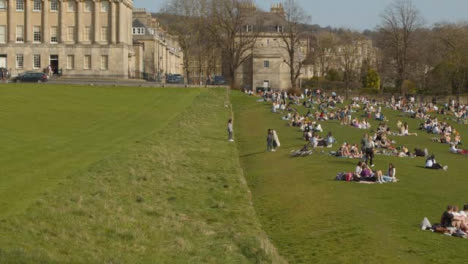 Wide-Shot-of-Large-Number-of-Pedestrians-On-Royal-Crescent-Green