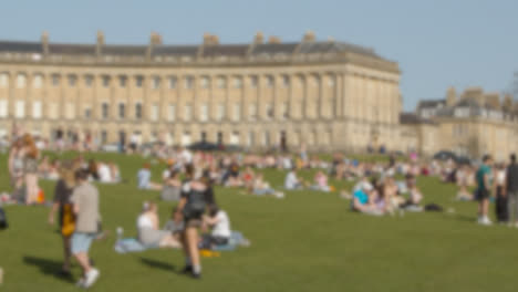 Defocused-Wide-Shot-of-Pedestrians-On-Royal-Crescent-Green-