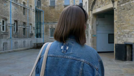 Tracking-Shot-Following-Young-Woman-Walking-Past-Oxford-Prison