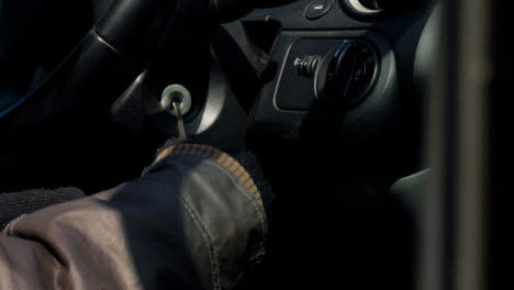 Long-Shot-of-Thief-Attempting-to-Access-Car-Ignition-with-Screwdriver