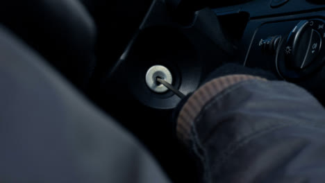 Over-the-Shoulder-Shot-of-Thief-Attempting-to-Access-Car-Ignition-with-Screwdriver