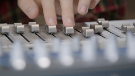 Close-Up-Shot-Following-Sound-Mixers-Hand-Adjusting-Faders