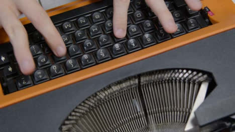 High-Angle-Shot-Looking-Down-On-Hands-Using-Typewriter