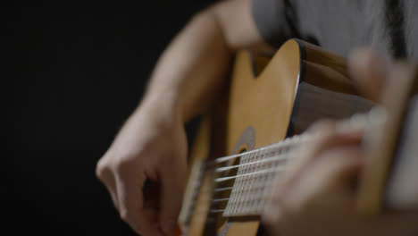Medium-Shot-of-Musicians-Hand-Playing-Acoustic-Guitar-Strings-