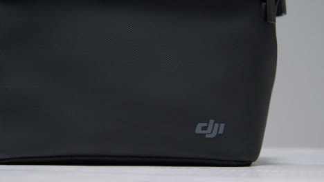 Pedestal-Shot-of-DJI-Bag-Sitting-On-Table