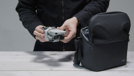 Medium-Shot-of-Person-Preparing-DJI-Mini-2-for-Flight-Part-1-of-2