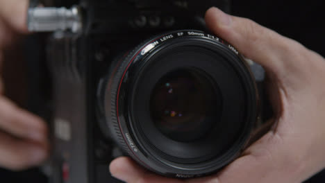 Close-Up-Shot-of-Person-Adjusting-Focus-On-Lens-and-Using-Touchscreen-Monitor