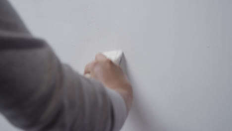 Over-the-Shoulder-Shot-of-Person-Painting-Wall-with-Paint-Brush