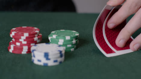 Tracking-Close-Up-Shot-from-Poker-Cards-to-Chips-Being-Thrown-In-