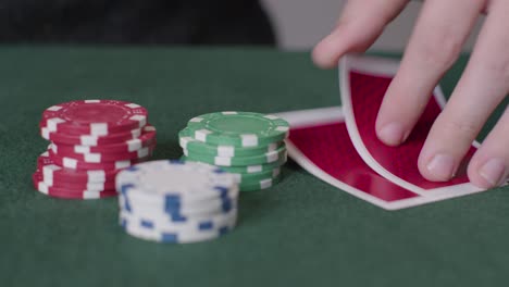 Tracking-Close-Up-Shot-from-Poker-Cards-to-Chips-Being-Thrown-In-
