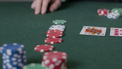 Close-Up-Shot-of-Poker-Chips-Being-Bet-by-Player