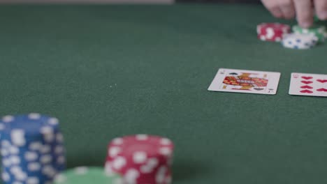 Close-Up-Shot-of-Poker-Chips-Being-Bet-by-Player