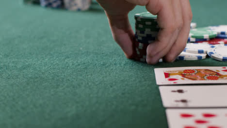 Tracking-Close-Up-Approaching-Pot-as-Poker-Player-Goes-All-In