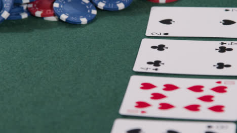 Tracking-Close-Up-Shot-Down-Community-Cards-to-Poker-Pot