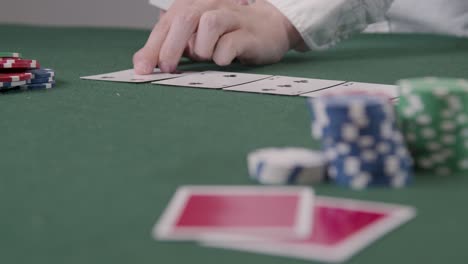 Pull-Focus-Shot-of-Poker-Dealer-Dealing-Turn-Card