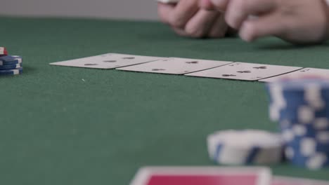 Pull-Focus-Shot-of-a-Poker-Dealer-Dealing-Turn-Card