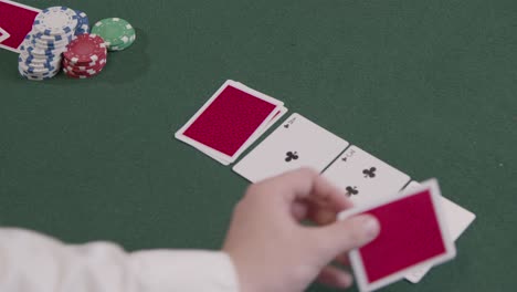Over-the-Shoulder-Shot-of-Poker-Dealer-Turning-Over-Turn-Card